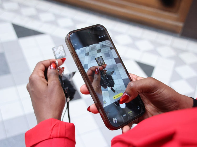 Une main tient la plaque QR Code My Self Key pendant qu'un téléphone la scanne et affiche le lien myselfkey.fr.